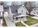 Charming two-story home with gray siding, a covered porch, and a well-maintained front yard at 902 N Anderson St, Elwood, IN 46036