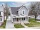 Charming two-story home with gray siding, a covered porch, and a well-maintained front yard at 902 N Anderson St, Elwood, IN 46036