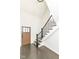 Bright foyer with hardwood floors, features a staircase with black metal railing at 902 N Anderson St, Elwood, IN 46036