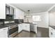 Contemporary kitchen features stainless steel appliances, black granite countertops, and white cabinets creating a modern cooking space at 902 N Anderson St, Elwood, IN 46036