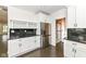 Elegant kitchen with custom white cabinets, a wine rack, stainless fridge, and granite countertops at 902 N Anderson St, Elwood, IN 46036