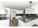 Modern kitchen with white cabinets, granite countertops, and stainless steel appliances at 902 N Anderson St, Elwood, IN 46036