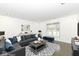 Staged living room with gray sofa, modern coffee table, and neutral decor showcasing a cozy and inviting space at 902 N Anderson St, Elwood, IN 46036