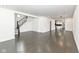 Spacious open-concept living area with hardwood floors, staircase, and seamless flow to kitchen offering a versatile design at 902 N Anderson St, Elwood, IN 46036