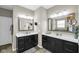 Bathroom featuring dual vanities with dark cabinets, quartz countertops, framed mirrors, and modern lighting at 9539 Rocky Shore Dr, McCordsville, IN 46055