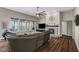 Inviting living room with hardwood floors, stone fireplace, and a comfortable leather sofa with a view of the outdoors at 9539 Rocky Shore Dr, McCordsville, IN 46055