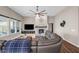 Spacious living room with a stone fireplace, large leather couch, and plenty of natural light from the windows at 9539 Rocky Shore Dr, McCordsville, IN 46055