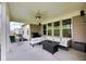 Covered outdoor patio with comfortable seating, ceiling fan, grill, and views of the backyard at 9539 Rocky Shore Dr, McCordsville, IN 46055