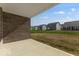 Open-air backyard has a patio space, offering views of neighborhood houses and blue skies at 1023 Grassy Br Dr, Indianapolis, IN 46239