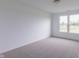 Bright bedroom features neutral carpet, white walls and trim, and a double window that allows ample natural light at 1023 Grassy Br Dr, Indianapolis, IN 46239