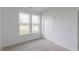 Bedroom featuring double window, closet, and neutral carpet at 1023 Grassy Br Dr, Indianapolis, IN 46239