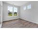 Bright bedroom with luxury vinyl plank flooring and large windows offering natural light at 1023 Grassy Br Dr, Indianapolis, IN 46239