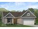 Charming one-story brick home with a two-car garage and manicured lawn at 1023 Grassy Br Dr, Indianapolis, IN 46239