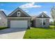 Charming single-story home with a two-car garage, well-maintained lawn, and neutral brick facade at 1023 Grassy Br Dr, Indianapolis, IN 46239