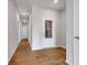 Inviting hallway with hardwood floors, recessed lighting, and a view of other rooms in the home at 1023 Grassy Br Dr, Indianapolis, IN 46239