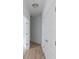 Bright hallway with white walls, light wood floors, and white doors on either side at 1023 Grassy Br Dr, Indianapolis, IN 46239