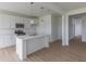 Bright kitchen with center island, stainless steel appliances and hardwood floors at 1023 Grassy Br Dr, Indianapolis, IN 46239