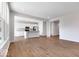 Open concept living space with a modern kitchen featuring white cabinets and a breakfast bar at 1023 Grassy Br Dr, Indianapolis, IN 46239