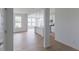 Bright open-concept space with a view of the kitchen, large windows, and hardwood floors at 1023 Grassy Br Dr, Indianapolis, IN 46239