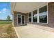 View of a covered patio with brickwork, large windows, and an open space to the lawn at 1023 Grassy Br Dr, Indianapolis, IN 46239