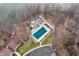 A stunning aerial view of a home with a private pool near the waterfront and a wooded surrounding at 108 Knoll Ct # A, Noblesville, IN 46062