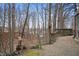 Landscaped backyard with mature trees, a stone path, and a wooden bridge at 108 Knoll Ct # A, Noblesville, IN 46062