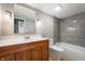 Updated bathroom with a wood vanity, shower-tub combo with tiled surround, and a mosaic tile floor at 108 Knoll Ct # A, Noblesville, IN 46062