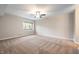 Bright bedroom with neutral walls, a ceiling fan, and plush carpeting; natural light shines through the window at 108 Knoll Ct # A, Noblesville, IN 46062
