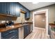 Kitchen features stainless steel appliances, dark blue cabinets, hardwood countertops, and hardwood floors at 108 Knoll Ct # A, Noblesville, IN 46062