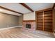 Inviting living room featuring a brick fireplace, custom-built shelving, and exposed beams for a blend of comfort at 108 Knoll Ct # A, Noblesville, IN 46062