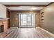 Sun-filled living room with a brick fireplace, built-in shelves, modern flooring, and a sliding glass door at 108 Knoll Ct # A, Noblesville, IN 46062