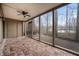 Enclosed sunroom with brick floors, a ceiling fan, large windows, and an exterior door at 108 Knoll Ct # A, Noblesville, IN 46062