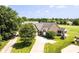Aerial view of the brick home with well-maintained landscaping, a screened-in porch, and a long driveway at 10844 Fairwoods Dr, Fishers, IN 46037