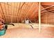 Unfinished attic space with exposed beams, offering potential for customization at 10844 Fairwoods Dr, Fishers, IN 46037