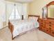 Comfortable bedroom showcases a dresser, large windows with curtains, and neutral carpet for a relaxing ambiance at 10844 Fairwoods Dr, Fishers, IN 46037