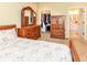 Cozy bedroom with wooden furniture, including a dresser with mirror, and a closet and bathroom entrance in view at 10844 Fairwoods Dr, Fishers, IN 46037