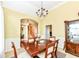 Formal dining room with traditional chandelier and doorway to living area at 10844 Fairwoods Dr, Fishers, IN 46037
