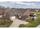 Beautiful red brick home with attached garage, screened in porch, and expansive driveway at 10844 Fairwoods Dr, Fishers, IN 46037
