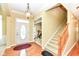 A bright foyer with hardwood floors, staircase, and an elegant chandelier at 10844 Fairwoods Dr, Fishers, IN 46037