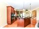 A spacious kitchen with dark wood cabinets, stainless steel appliances, and granite countertops at 10844 Fairwoods Dr, Fishers, IN 46037