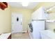 Well-equipped laundry room with white cabinets and modern appliances at 10844 Fairwoods Dr, Fishers, IN 46037