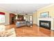 Open-concept living area with fireplace, hardwood floors, and seamless flow to the kitchen at 10844 Fairwoods Dr, Fishers, IN 46037