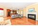 Bright living room with fireplace and view of the kitchen at 10844 Fairwoods Dr, Fishers, IN 46037
