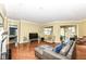 Open-concept living space featuring hardwood floors, neutral paint, and connecting rooms at 10844 Fairwoods Dr, Fishers, IN 46037