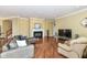 Spacious living room with a fireplace, TV, and hardwood floors creates a welcoming atmosphere at 10844 Fairwoods Dr, Fishers, IN 46037