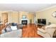 A cozy living room featuring a fireplace, hardwood floors, and comfortable seating at 10844 Fairwoods Dr, Fishers, IN 46037