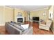 Inviting living room boasts a fireplace, large TV, and hardwood floors, perfect for relaxation at 10844 Fairwoods Dr, Fishers, IN 46037
