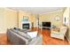 A bright living room with hardwood floors, a fireplace, and a large television at 10844 Fairwoods Dr, Fishers, IN 46037