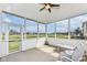 Bright screened porch with outdoor seating and golf course views is perfect for relaxing and entertaining guests at 10844 Fairwoods Dr, Fishers, IN 46037