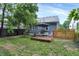 Relaxing backyard features a deck with an umbrella and privacy fence at 112 S Spencer Ave, Indianapolis, IN 46219